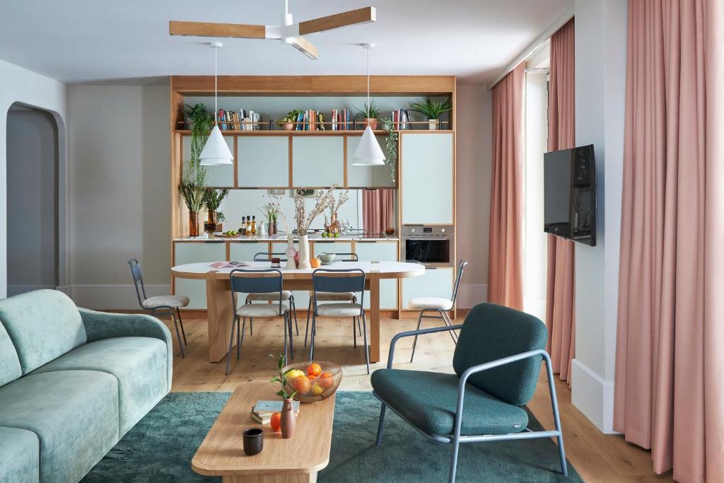 a living room with a couch and a table and chairs at Turing Locke Cambridge in Cambridge