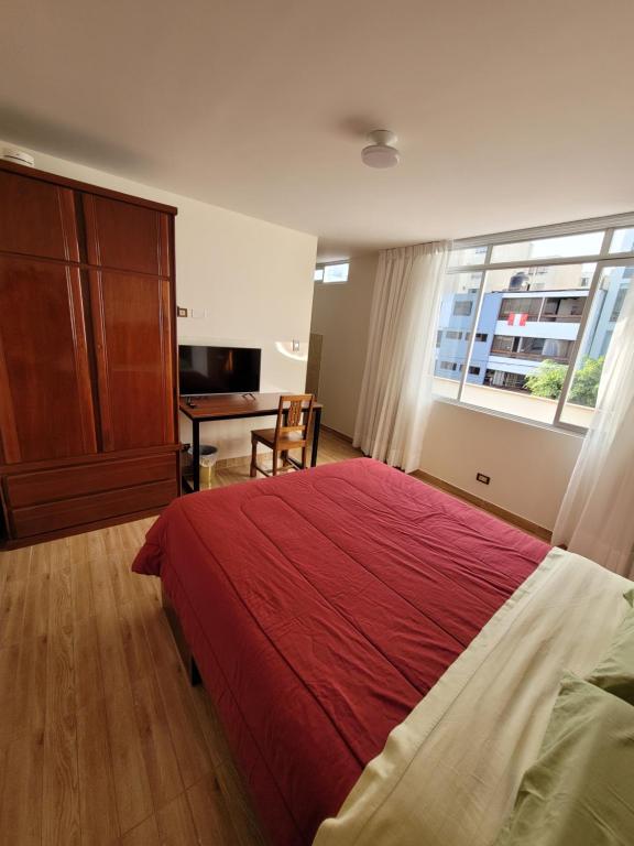 sypialnia z łóżkiem, biurkiem i oknem w obiekcie Habitación con baño propio para 2 personas como máximo w mieście Lima