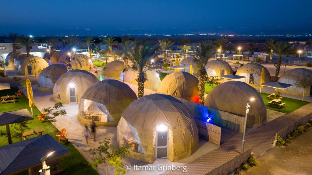 an overhead view of a group of domes at night at Camp Sahara in Kalia