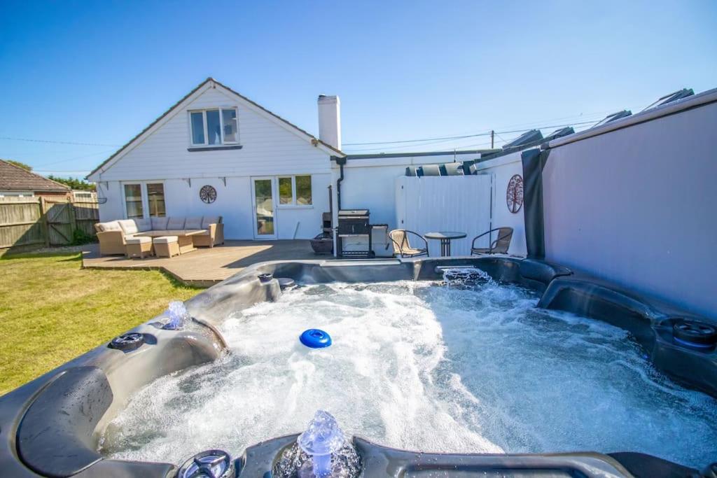 a hot tub in the backyard of a house at Bancroft - Camber Sands - East Sussex in Camber