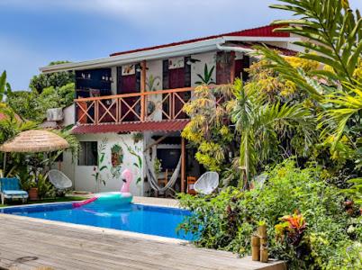 a house with a swimming pool in front of it at Mecca in Puerto Viejo