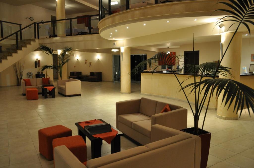 a lobby with couches and chairs and a plant at Kohylia by La Scala Beach in Limenas
