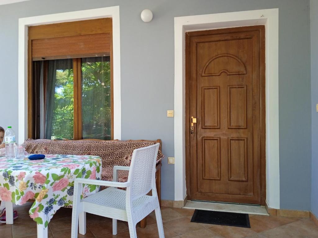 a dining room with a table and a wooden door at Μαρία in Gera