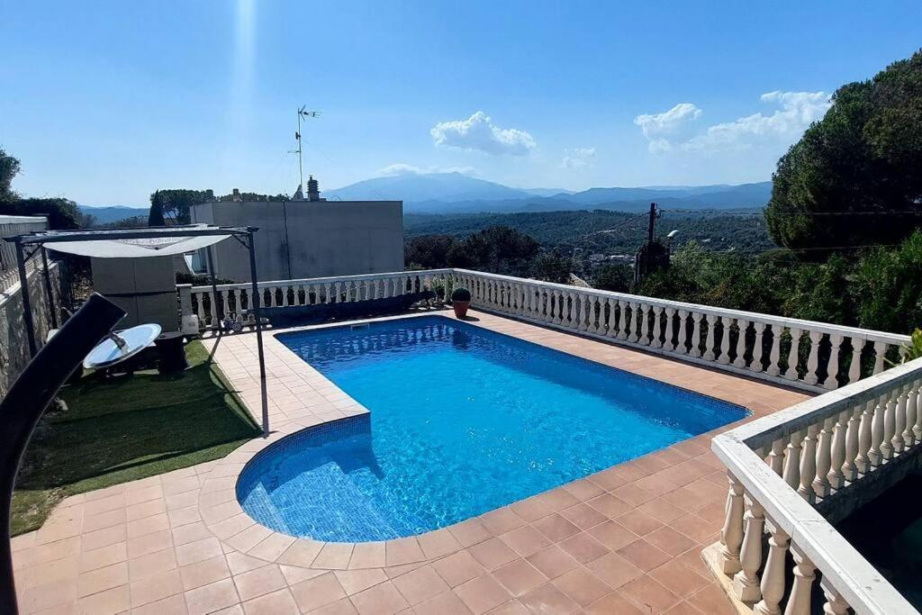 a swimming pool on a balcony with a view of the mountains at Bravaholidays-600-Mas Altaba in Terra Brava