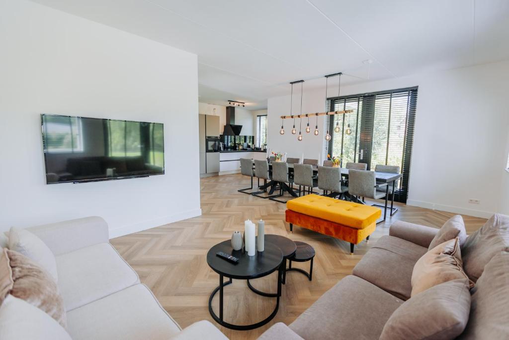 a living room with a couch and a table at Brand new bright luxurious villa in Amsterdam! in Amsterdam