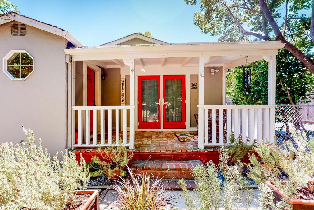 a home with a red front door and stairs at Tranquil Haven Cottage Retreat in San Rafael