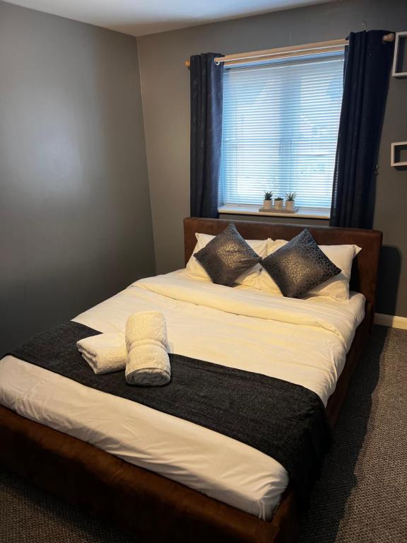 a bedroom with a large bed with a window at VRLProperties. in Gloucester