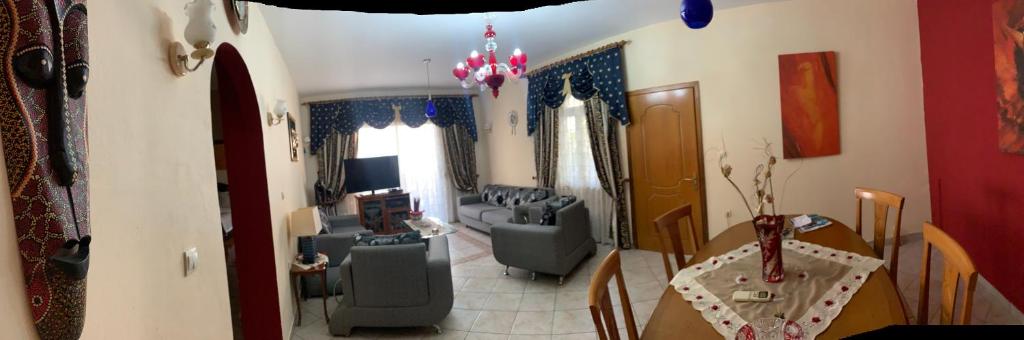 a living room with a couch and a table at Christina's house with 2 bedrooms and free parking in Gjirokastër