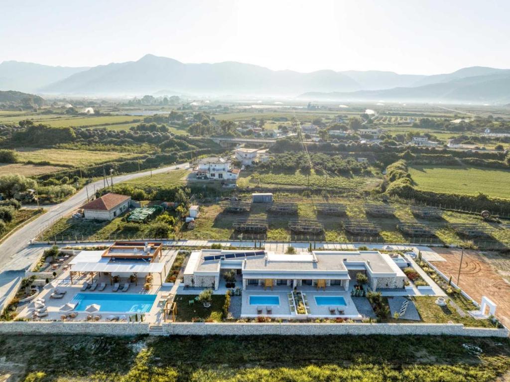 an aerial view of a villa in the middle of a field at Trinity Design Suites in Valanidorachi