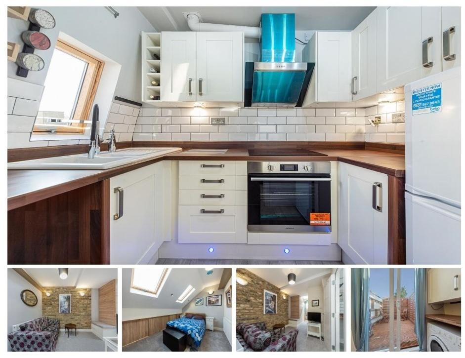 uma cozinha com armários brancos e um forno com placa de fogão em Newly Refurb Period 1-Bed Apartment with Roof Terrace, 47 sqm-500 sqft, in Putney near River Thames em Londres