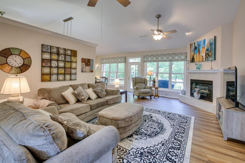 a living room with a couch and a fireplace at Hot Springs Village Home with Golf Course View in Hot Springs Village