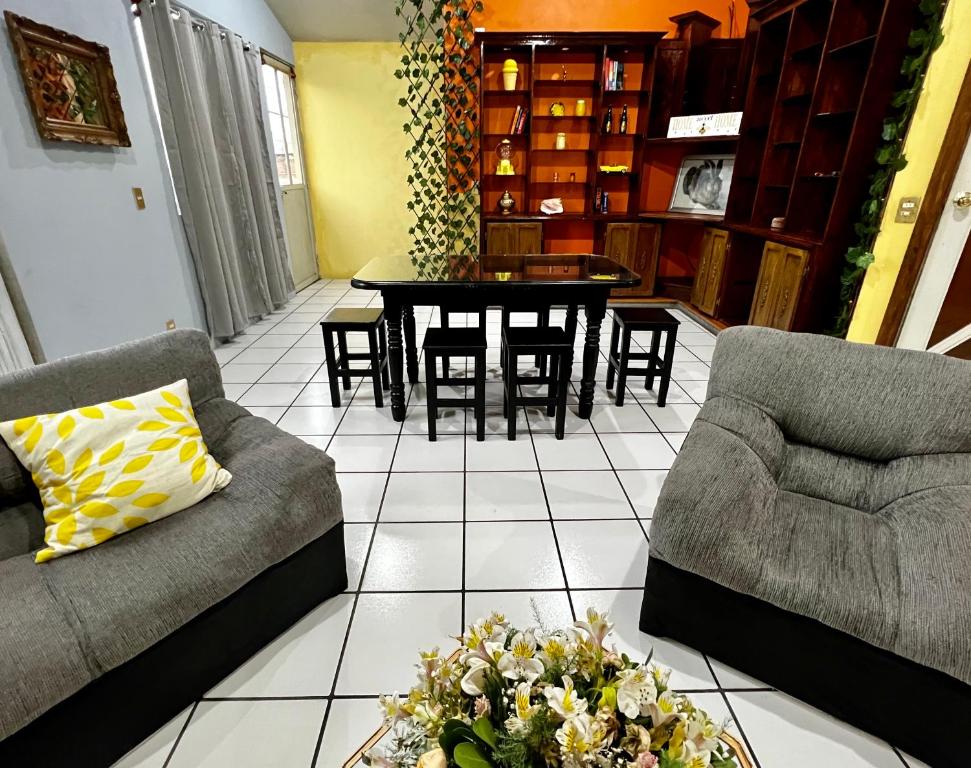 a living room with a couch and a table and chairs at VANILLA appartment in Ciudad Hidalgo