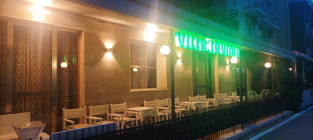 a restaurant with tables and chairs on the side of a building at Villa Lavinia in Rimini