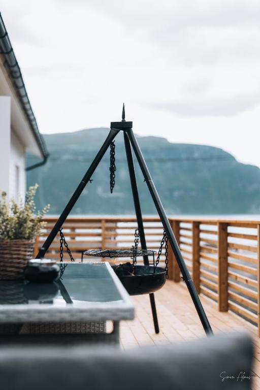 a swing on a deck with a laptop on it at Alpan Apartments, Lyngenfjord in Olderdalen