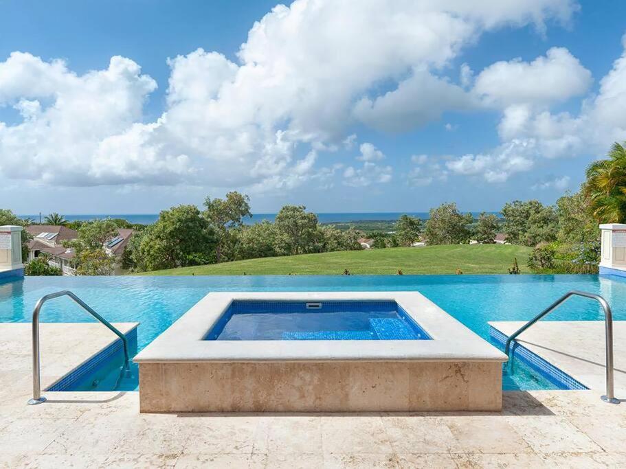 a swimming pool with a view of the ocean at ZenBreak Vuemont #245 in Saint Peter