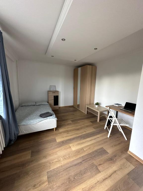 a bedroom with a bed and a desk at Rooms4Less in Gdańsk