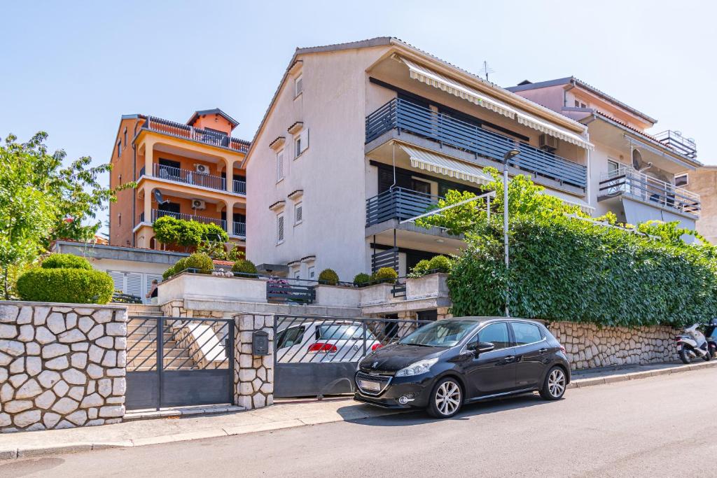 a car parked in front of a building at Apartment Crikvenica 5494c in Crikvenica