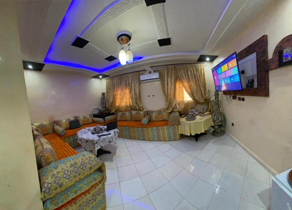 a living room with a couch and a tv at Modern Moroccan apartment near the beach in Safi in Safi