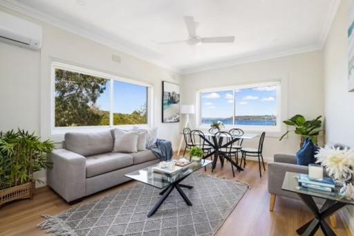 a living room with a couch and a table at Little Manly Getaway in Sydney