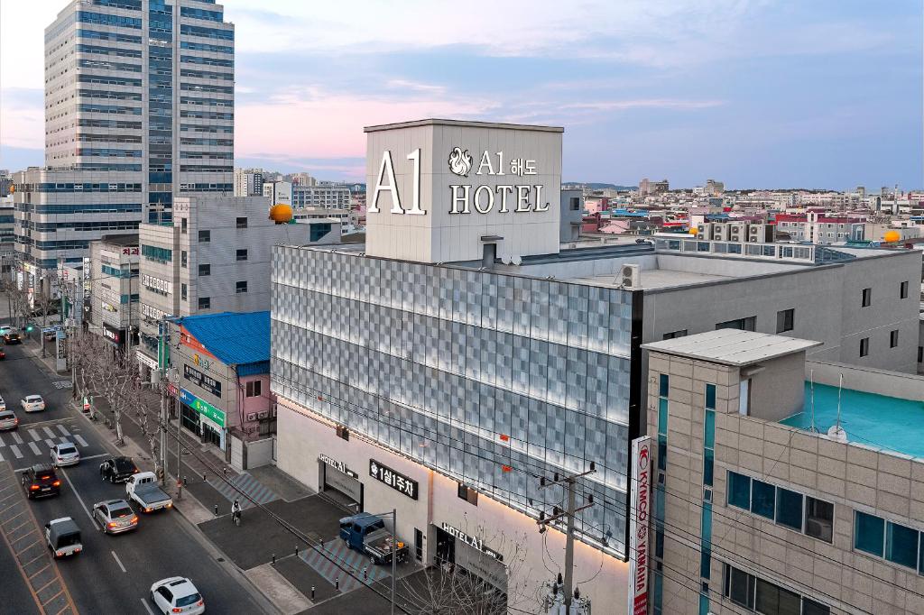 a building with a hotel sign on top of it at Pohang A1Hotel Haedo in Pohang