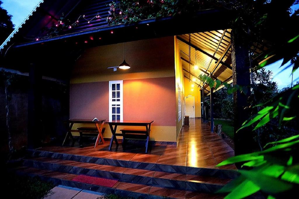 a patio with a table and chairs on it at Agronest Farm & Resort By Teal Luxury Stay in Wayanad