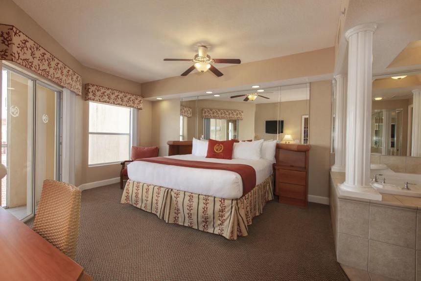 a bedroom with a bed and a bathroom with a tub at Kay's Sweet Suite Near Disney in Orlando