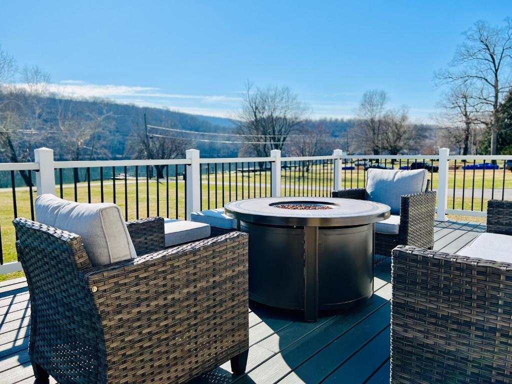 a patio with a table and chairs on a deck at Riverfront House in Harpers Ferry in Harpers Ferry