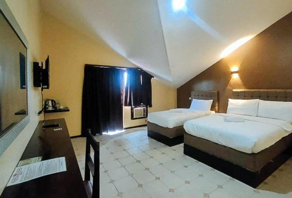 Postel nebo postele na pokoji v ubytování RedDoorz at Carlton-Martin Hotel Masbate City