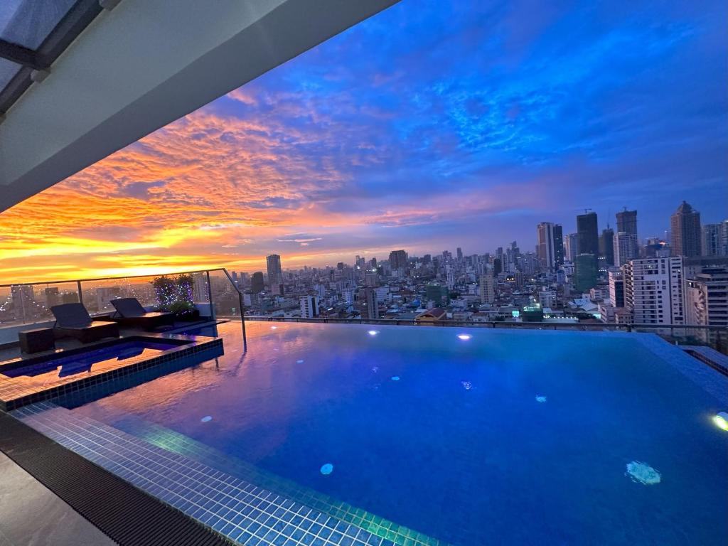 a swimming pool on top of a building with a city skyline at Parc21 Luxury Boutique Hotel in Phnom Penh