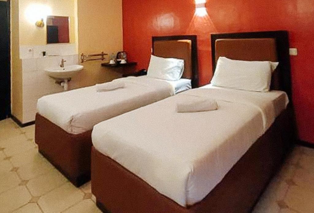 Postel nebo postele na pokoji v ubytování RedDoorz at Carlton-Martin Hotel Masbate City