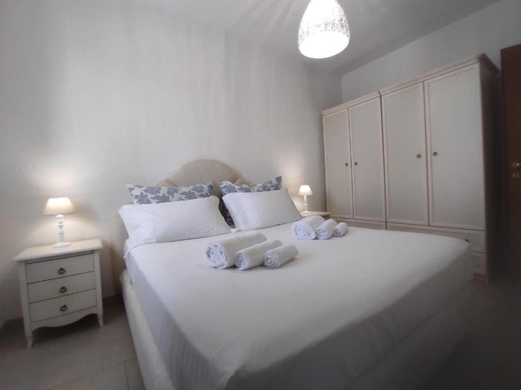 a bedroom with a white bed with towels on it at Villa Adele in Torre Santa Sabina