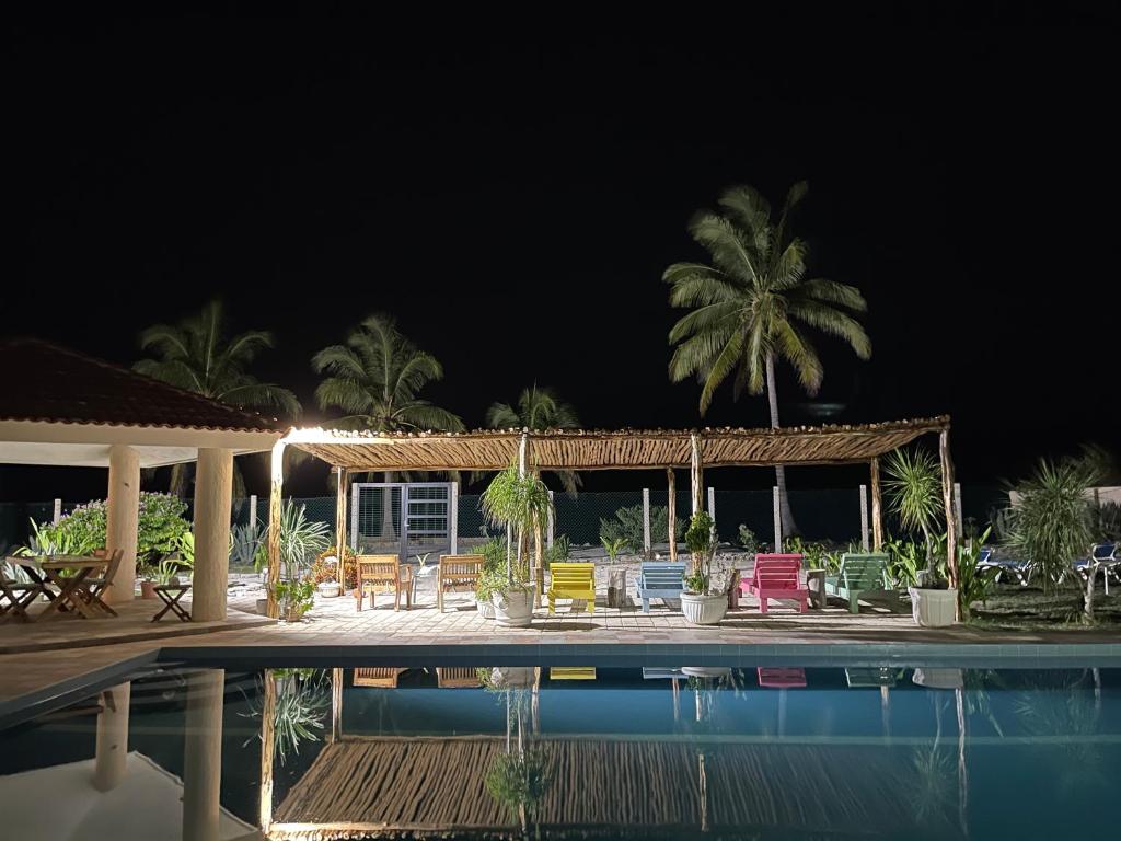 a house with a swimming pool at night at Casa BreMar - Only adults in Celestún