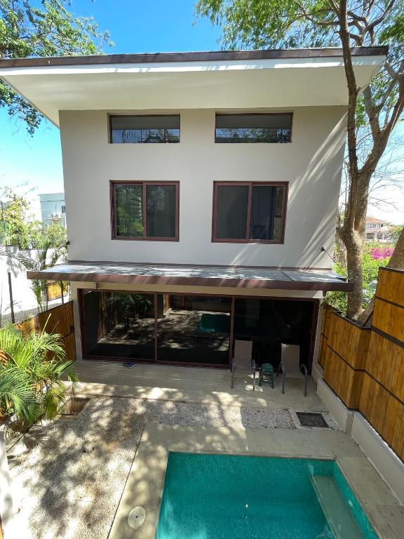 a house with a pool in front of it at Green Turtle Townhome #1 Private Pool & Garden 300 Mtrs to Beach in Tamarindo