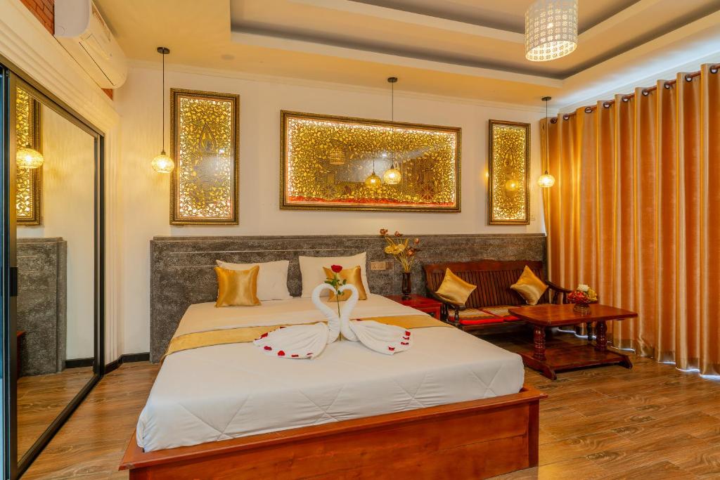 Postel nebo postele na pokoji v ubytování Angkor Rithy Boutique