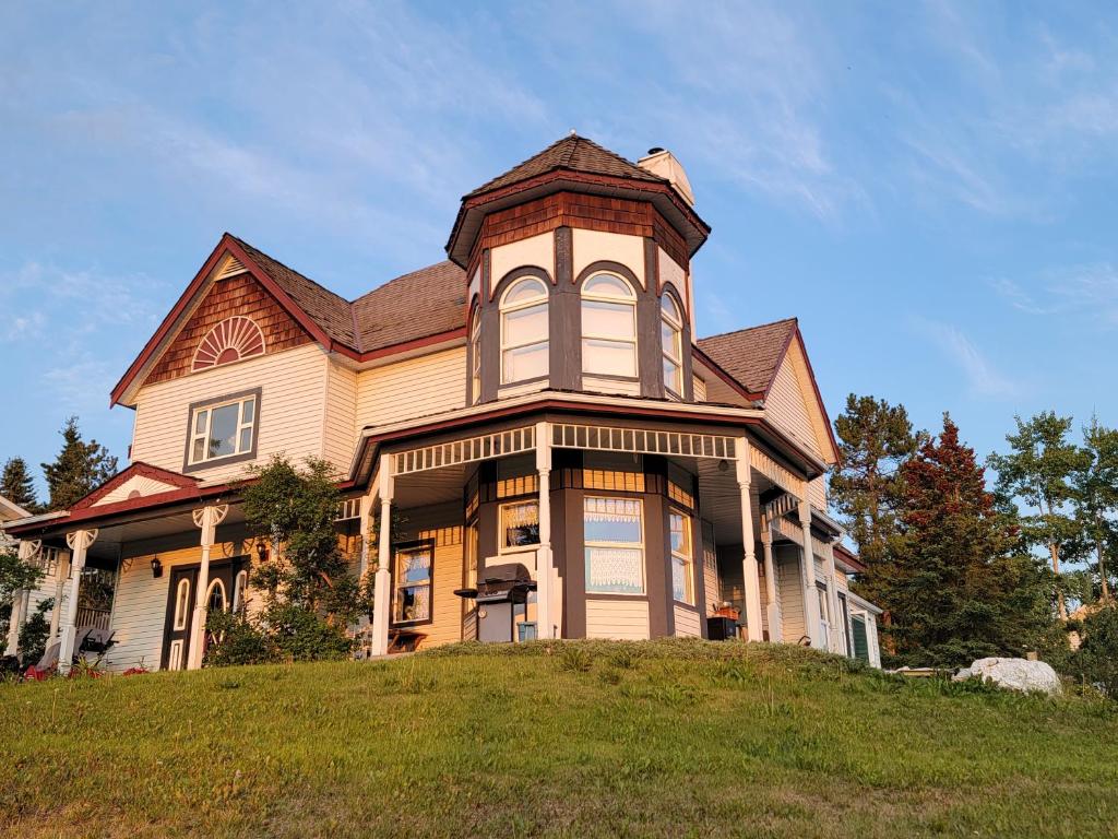 a large house on top of a hill at Bluejay Suites B&B in Whitehorse