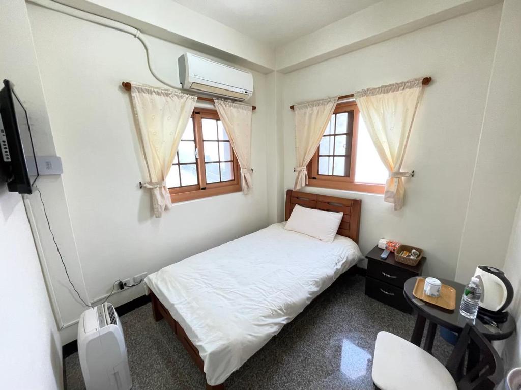Postel nebo postele na pokoji v ubytování 芹壁山城民宿 Chinbe Hill Village House B&B