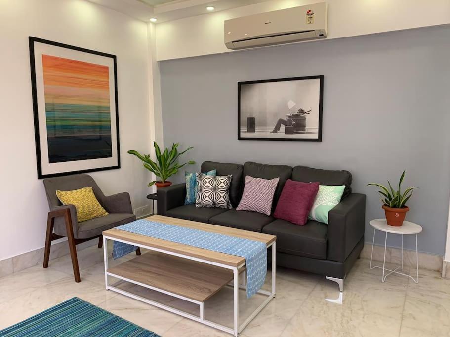 a living room with a couch and a table at Mon Desire 1, Perry Cross Rd, Bandra West by Connekt Homes in Mumbai