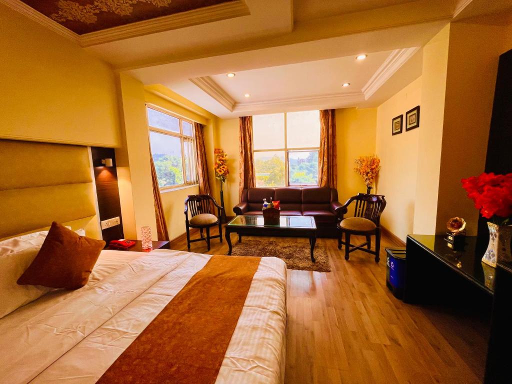 a bedroom with a bed and a living room at Rio Classic, Top Rated & Most Awarded Property in Haridwar in Haridwār