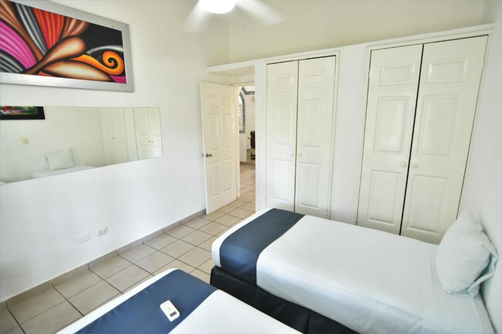 Postel nebo postele na pokoji v ubytování Tulipanes Cancun