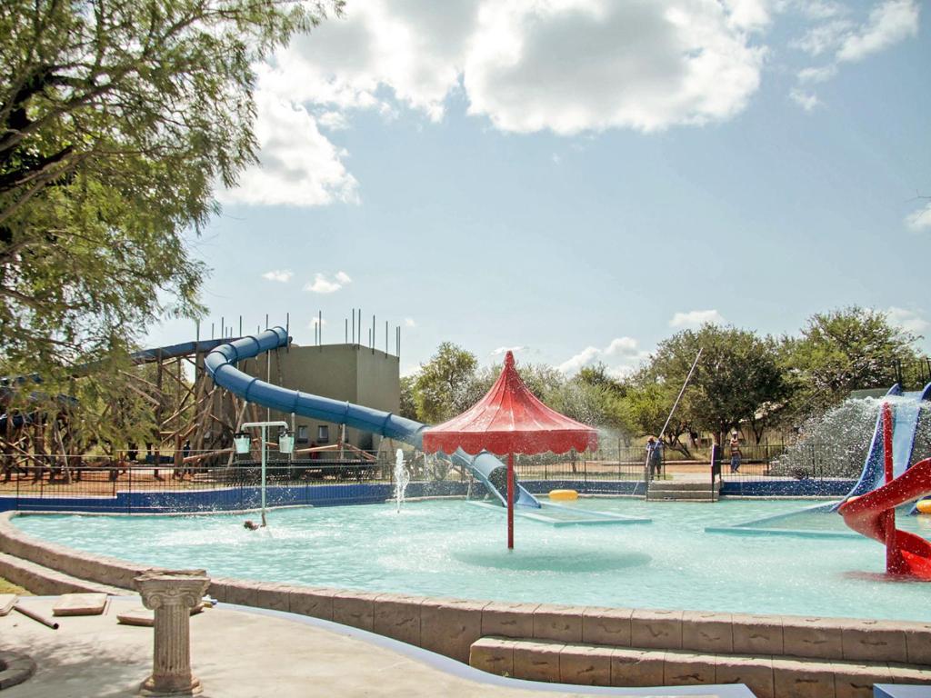 a water park with a slide and a water slide at Lethabong Lodge in Thabazimbi