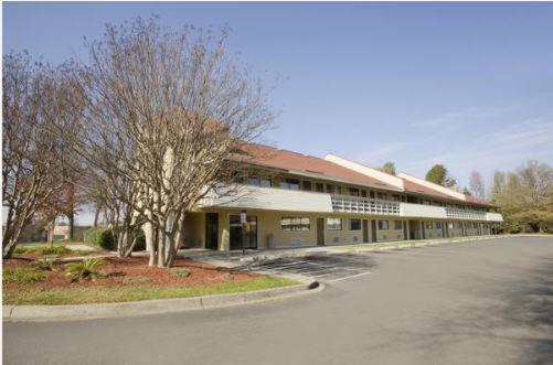 a large building on the side of a road at Royal Inn in Charlotte