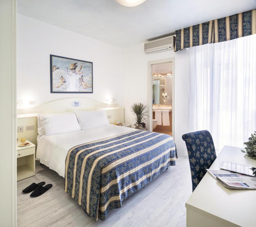 Postel nebo postele na pokoji v ubytování Hotel San Michele