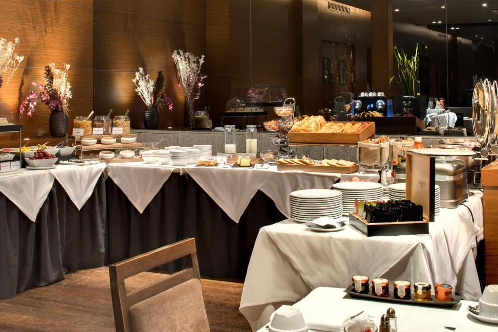 a buffet line with white tables with food on them at Splendid Etoile in Paris