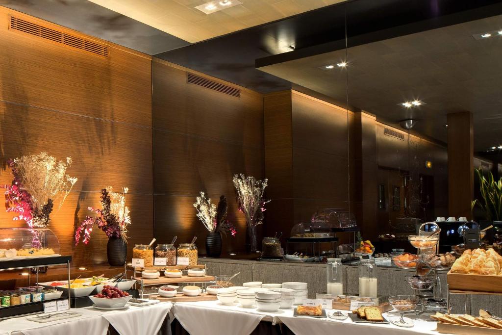 a buffet line with white tables with food on them at Splendid Etoile in Paris