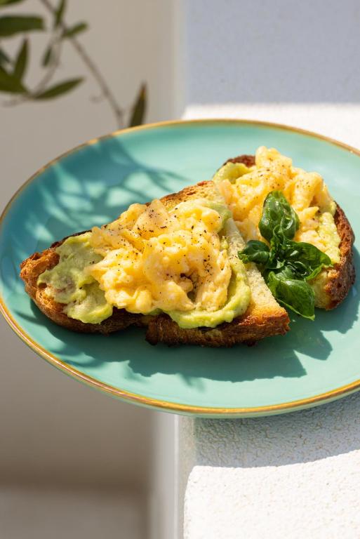 a piece of toast with eggs and greens on a plate at Dimora Talenti in Polignano a Mare