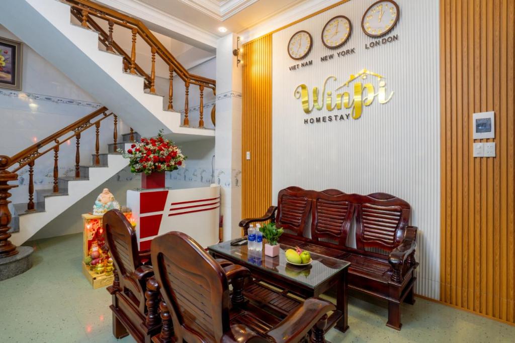 a restaurant with a table and chairs and stairs at WINPI Homestay & Hotel in Thôn Lại Thê