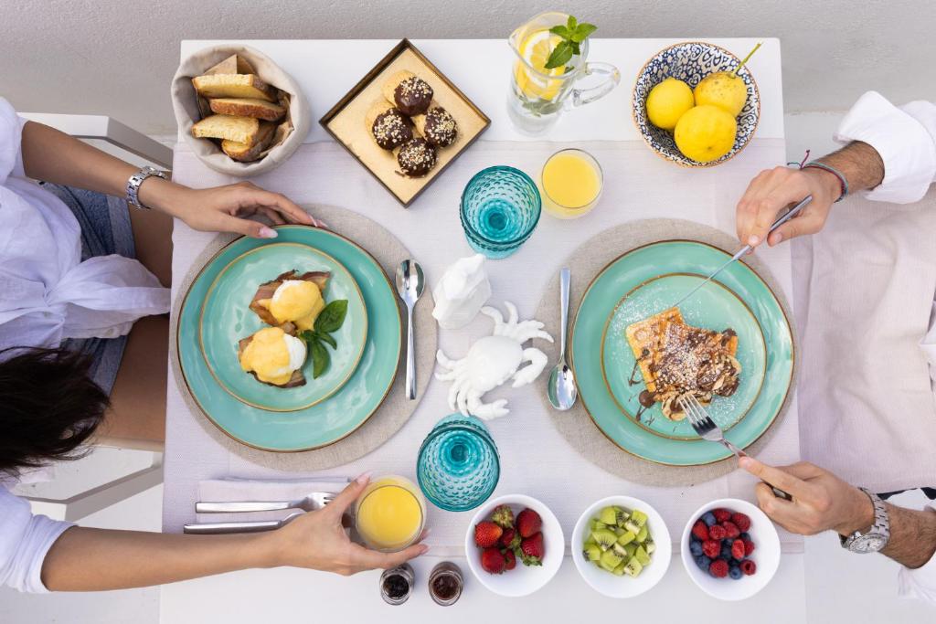 a group of people sitting at a table eating breakfast at Dimora Talenti in Polignano a Mare