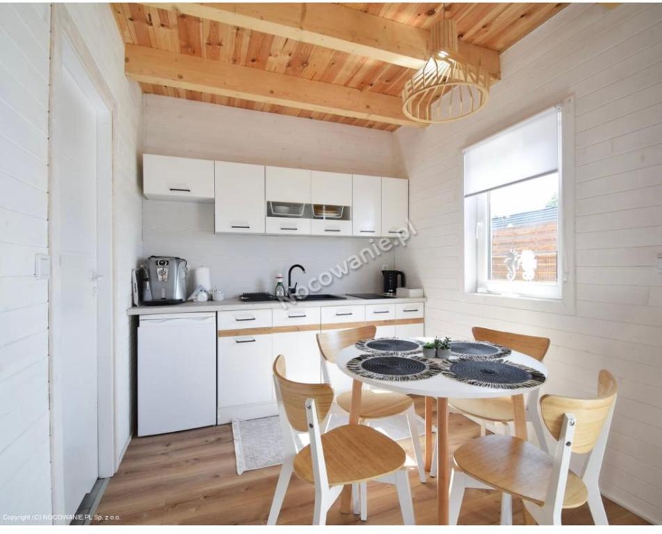 a kitchen with a table and chairs in a room at Amara Houses in Rewal