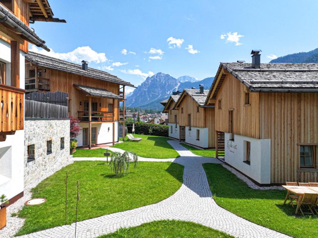 a courtyard in a house with mountains in the background at Liondes Chalets in San Vigilio Di Marebbe