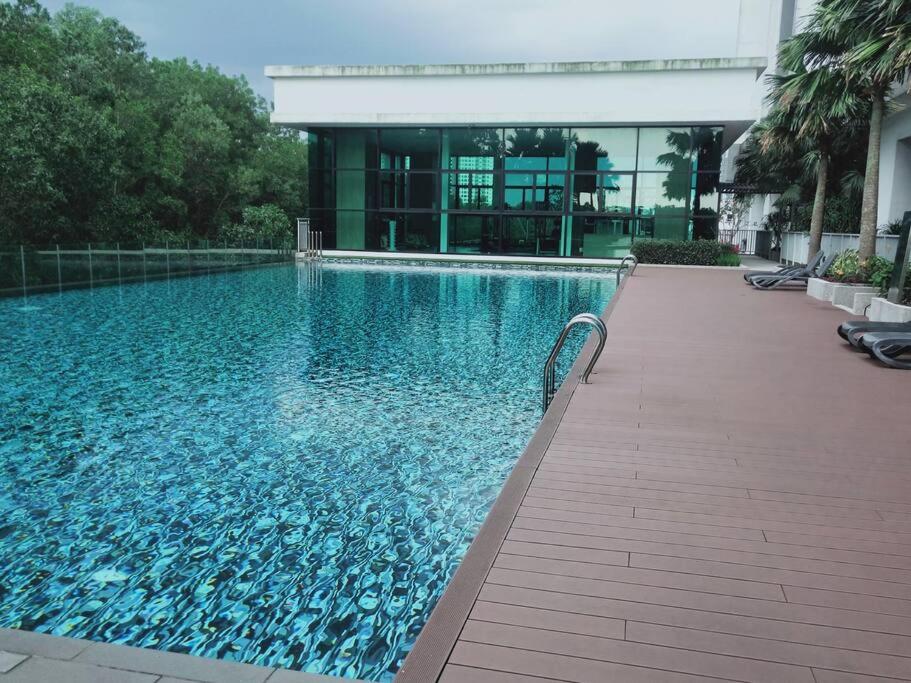 a swimming pool in front of a building at Cozy Sky Loft 5 Guests with Netflix & Facilities L28 in Johor Bahru